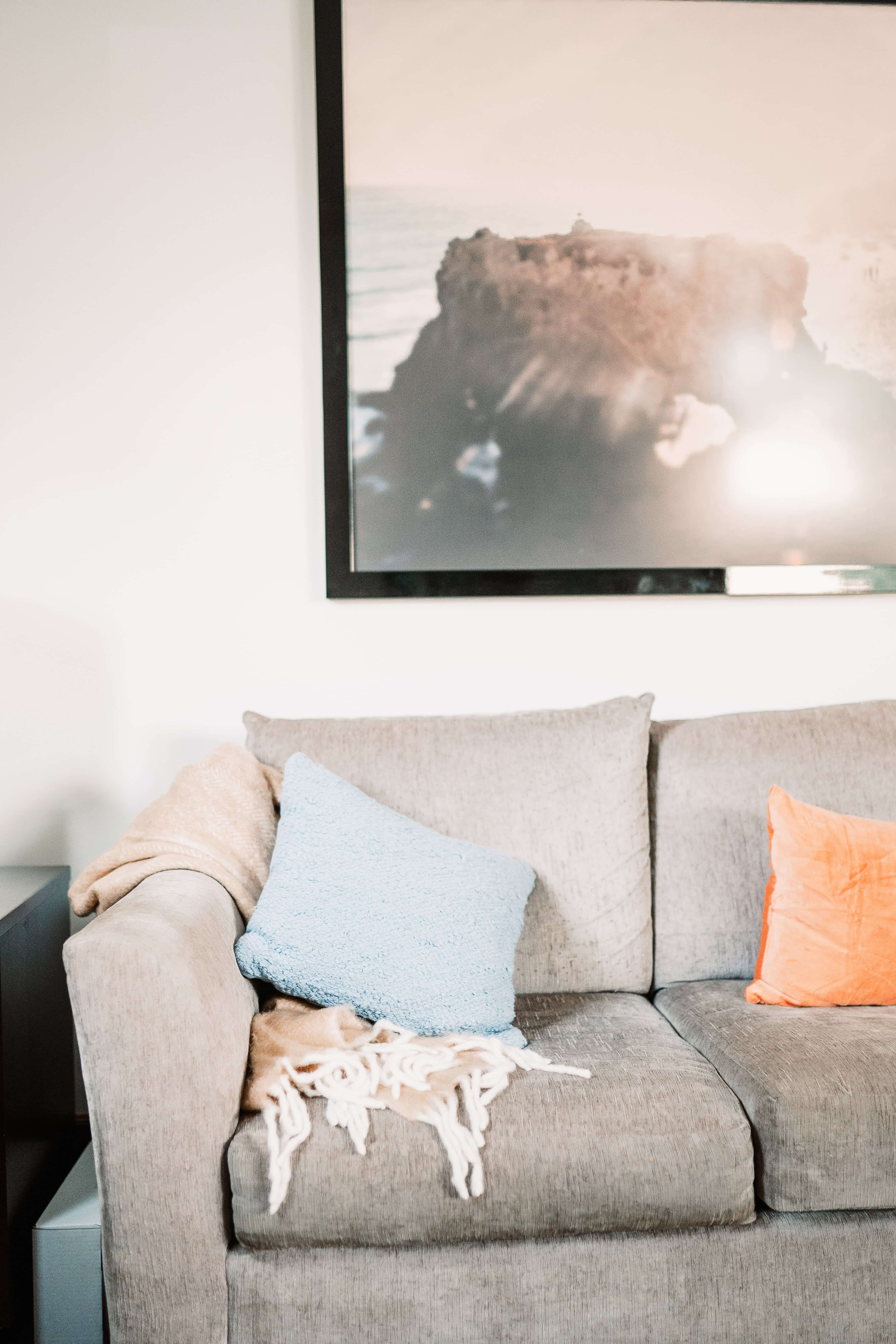 A comfy couch and landscape photo are shown at Dr. Ruth Viehoff's Indianapolis therapy office.