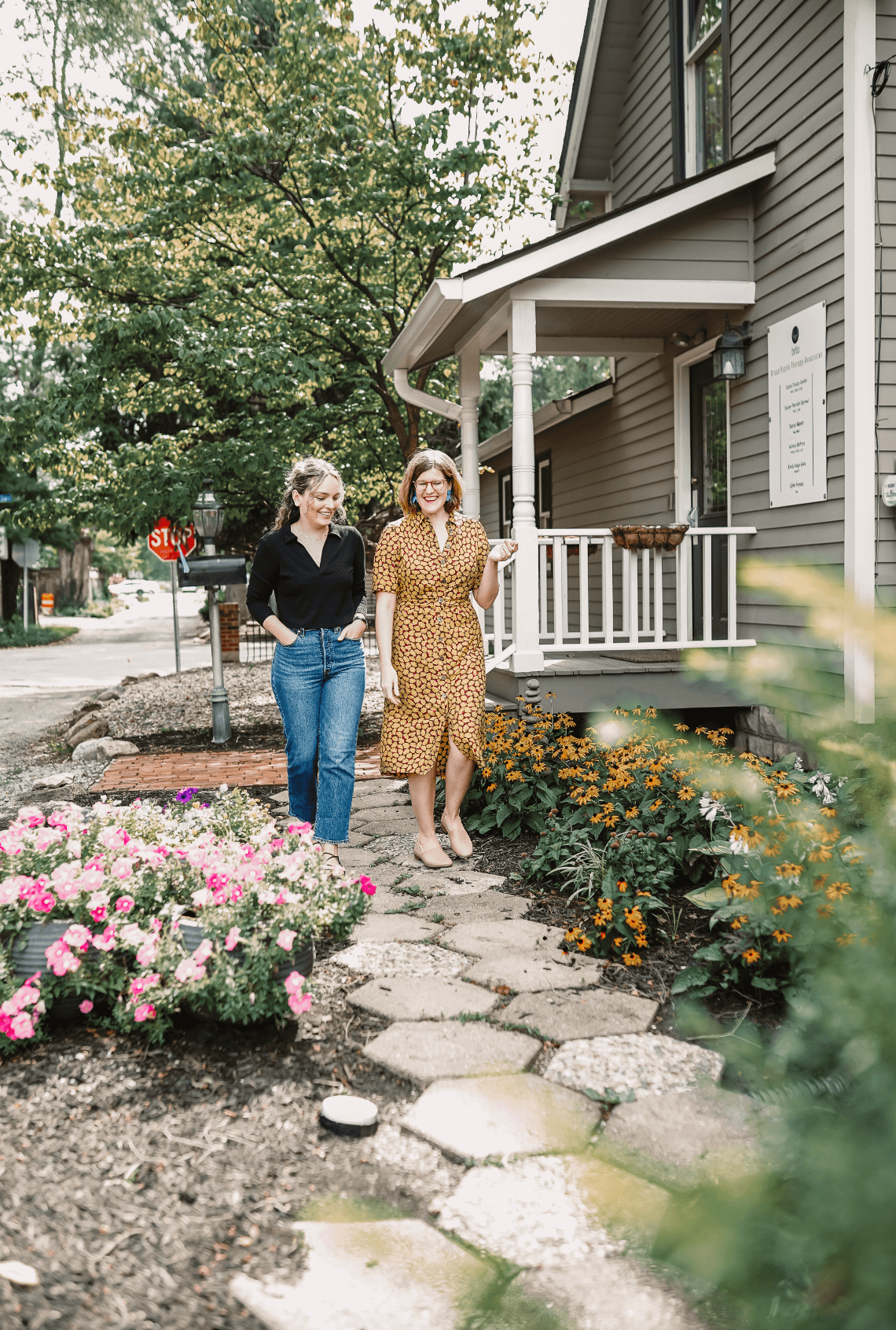 Dr. Ruth Viehoff, anxiety therapist & psychologist, is walking on a garden path with a young adult female therapy client outside of her Indianapolis office.