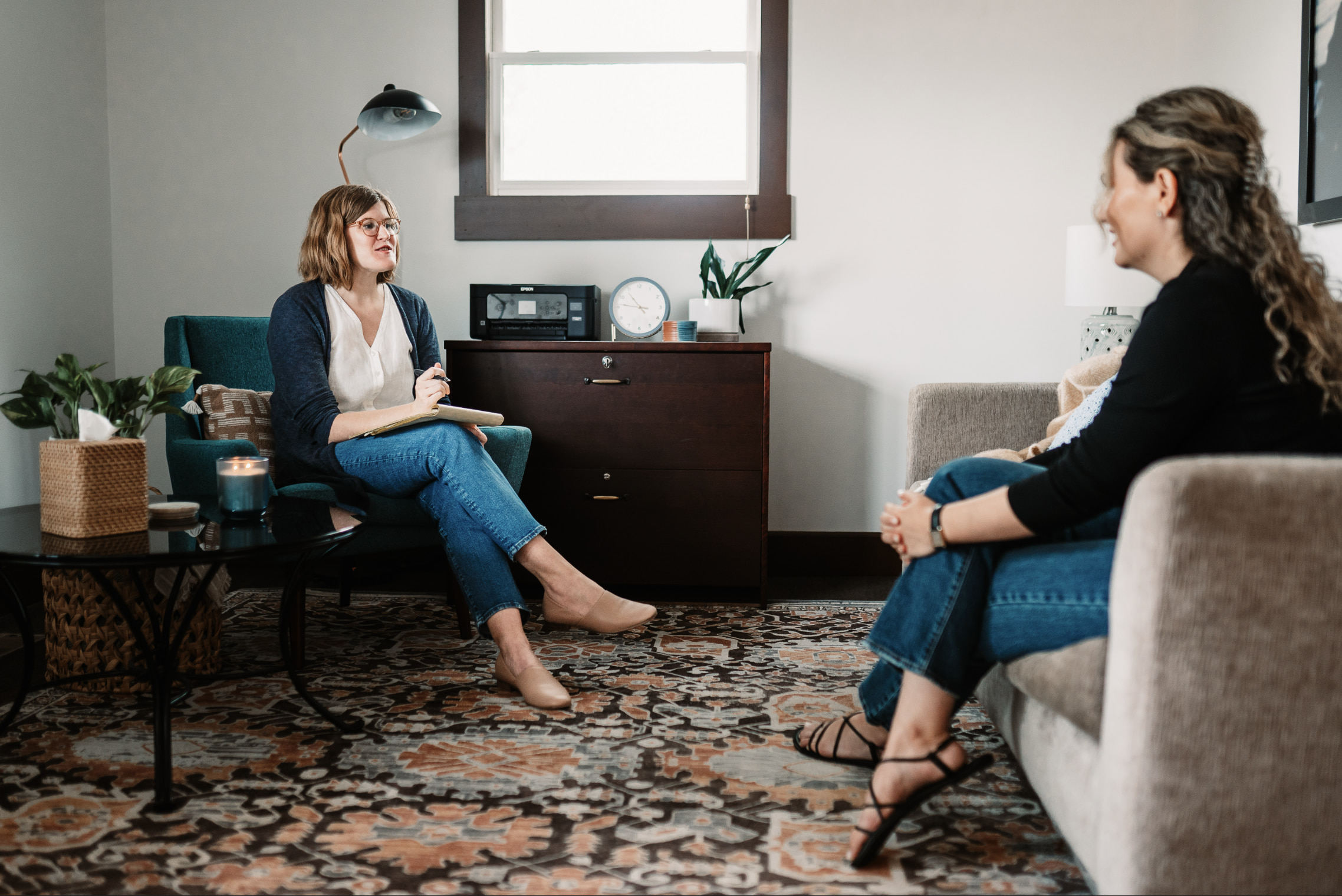 Dr. Ruth Viehoff is speaking during a therapy session with a female client in her Indianapolis office.