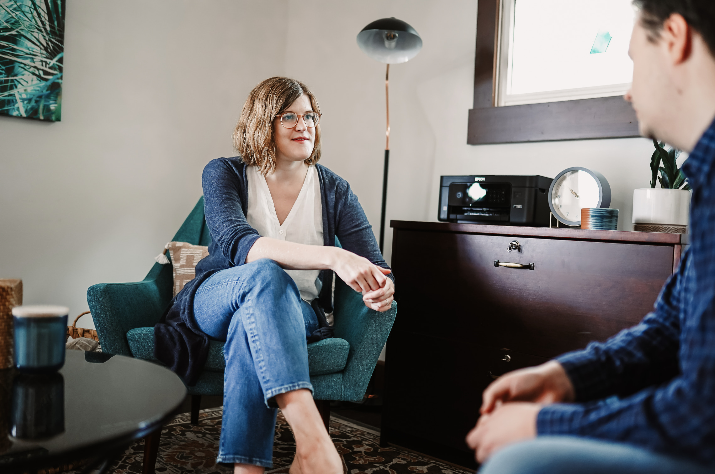 Dr. Ruth Viehoff is seated in a therapy session with a male client in her Indianapolis therapy office.